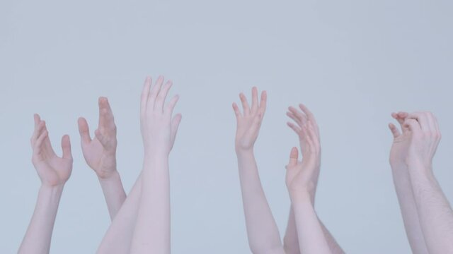 On a white background, the hands of teenagers reach for the top