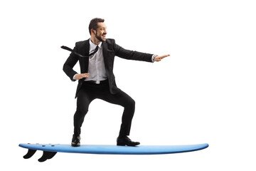 Full length profile shot of a businessman riding a surfboard - obrazy, fototapety, plakaty