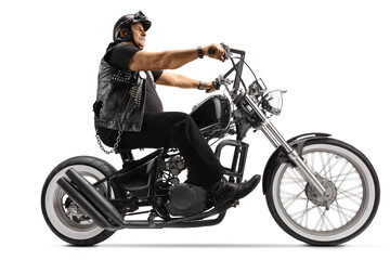 Obraz na płótnie Canvas Mature biker riding a chopper motorbike