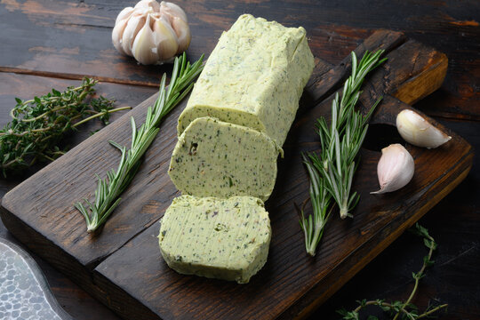 Homemade Herb Butter with garlic, on old dark  wooden table background