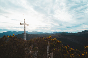 Christian cross on top of a mountain in Basque Country on a cloudy day