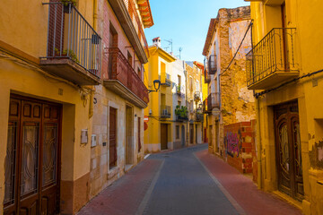 Fototapeta na wymiar Càlig, Baix Maestrat, Valencian Community, Spain. Beautiful historic street. Traditional and typical spanish village. Part of the Taula del Sénia free association of municipalities.