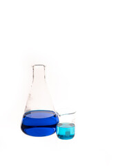 Conical flat flask and Berzelius Beaker filled with colorful blue and teal liquid. Chemistry research and lab instruments with copy space available