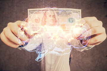 Multi exposure of brain drawing hologram and us dollars bills and man hands. Ai invest concept