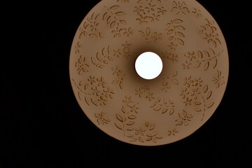 Abstraction. Lamp shade with a brightly glowing lamp. Bottom up view