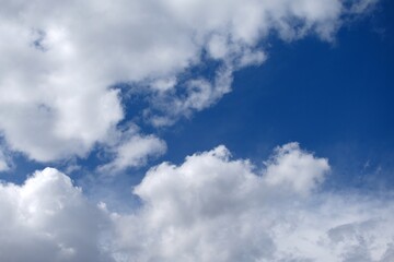Fluffy white clouds on blue spring sky. Beautiful background
