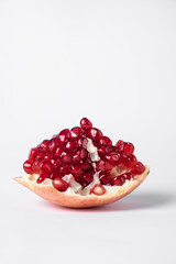 Broken ripe pomegranate fruit on a white background. juicy pomegranate berries. background.
