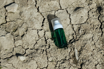 Cosmetic bottle on gray background.Green plastic bottle. Bootle spray for the bathroom