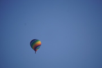 Background photo of a colorful balloon in the sky.