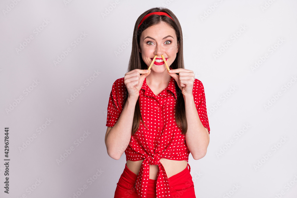 Poster photo of crazy childish girl hold two french fries funny face wear red dotted blouse isolated grey c