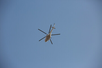 white helicopter in the sky without clouds