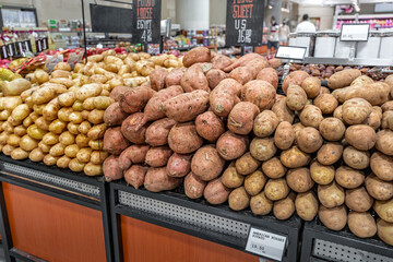 American sort of Russet potatoes on supermarket shelves for sale. Farm crop and vegetable concept with gluten and starch