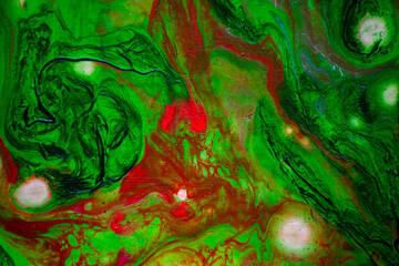 Texture in the style of fluid art. Abstract background with swirling paint effect. Liquid acrylic paint background. Green and red colors.
