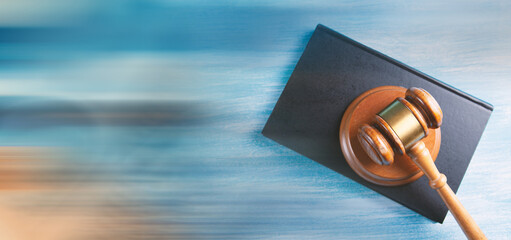 Wooden judge gavel and law books.