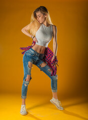 Young Woman In Yellow Tanktop And Eye Glasses Against Yellow Background