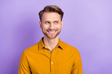 Fototapeta premium Photo of funny tricky young gentleman dressed yellow shirt smiling looking empty space isolated violet color background