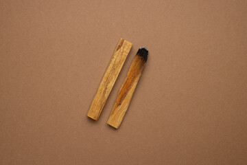 Palo Santo sticks on a brown background.Aromatherapy and religious rites and meditations.Scattered sticks of Palo Santo . Organic holy tree incense from Latin America.