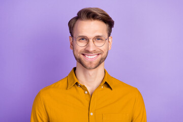 Photo of satisfied young man beaming smile look camera wear glasses isolate don violet color background