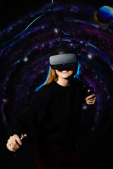 Young fair-skinned girl playing a game using virtual reality glasses