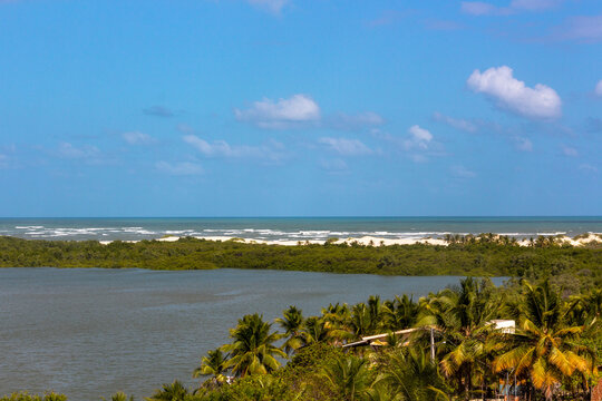 Vegetation and sand dunes of the dry mangrove (Dunas do Mangue Seco) in Bahia providing a beautiful view of the blue sea. A famous place of recording of the soap opera Tieta.