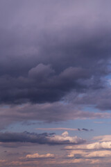 Storm sky. Dark grey, violet and white big cumulus rainy clouds on blue sky background, cloud texture, thunderstorm	