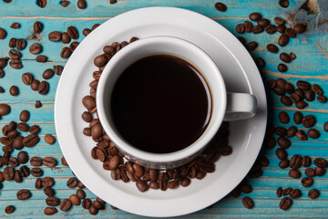  top view cup of coffee with scattered coffee beans