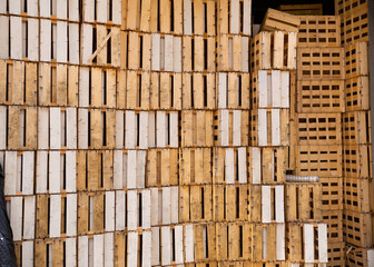 Closeup of empty slatted wooden crates stacked in pile