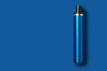 Disposable e-cigarette on blue isolated background. The concept of modern smoking, vaping and nicotine. Top view