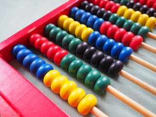 Education concept - abacus with many colorful beads. Red, blue, green, black, yellow details on the...