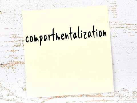 Yellow sheet of paper with word compartmentalization. Reminder concept
