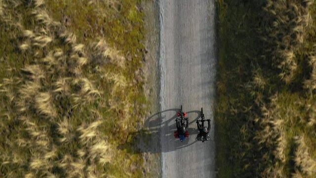 Man and woman riding bikes on dirt road, Nes, Friesland, Netherlands