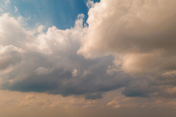 Texture of Dramatic warm cumulus clouds on the blue cold sky is a picture with perspective. Low...