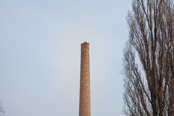 Broken Red brick chimney from an abandoned factory dating back from the industrial revolution in a...
