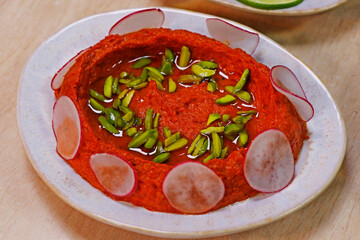 selection of libanese arabic food mezze, includes hummus, muhammara, moutabal, taboule and vine leaves