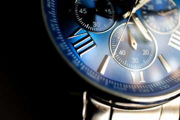 Macro Close Up of Roman Numeral Seven on Blue Faced Chronograph Watch