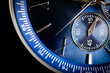 Macro Close Up of Roman Numeral Ten on Blue Faced Chronograph Watch