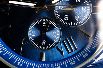 Macro Close Up of Complications and Roman Numeral Eight on Blue Faced Chronograph