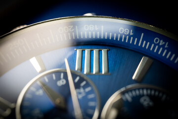 Macro Close Up of Roman Numeral Four on Blue Faced Chronograph Watch