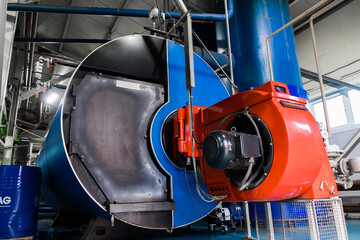 Two large blowers of an industrial heating system with burner housing.