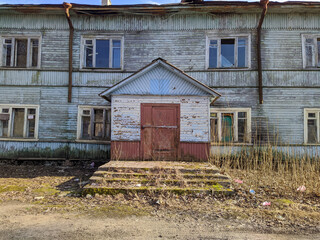 old and broken wooden house in the early spring during the day