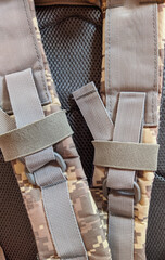 gray straps on the hiking backpack closeup photo