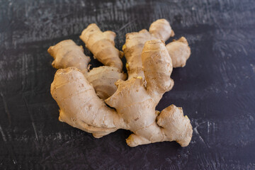 fresh ginger root on rustic board blackground