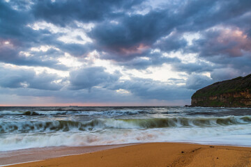 Sunrise at the seaside with a cloudy sky