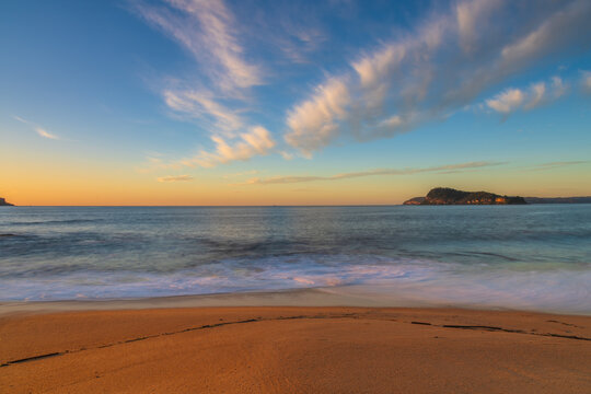 Sunrise seascape with scattered high cloud