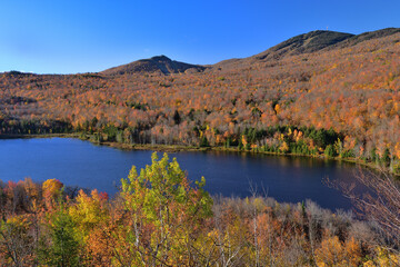 Orford National Park SEPAQ, Cherry pond during fall season, autumn colors, Orford and Giroux Mounts background