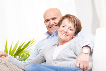 Affectionate loving couple relaxing together at home on a sofa