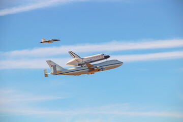 Shuttle Endeavour final flight carried by shuttle carrier aircraft, on top is T-38 trainer guarding.