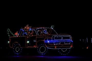 Neon lights of Santa Claus in a pickup truck.