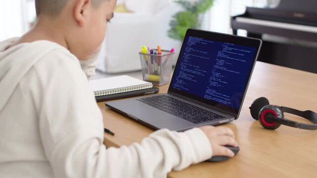 Back Rear View Of Young Asian Kids Boy Using Computer Laptop Coding Python Language Programming For Big Data Computer Science Lesson Or Tech Club In Online School Remotely Learn Online School.