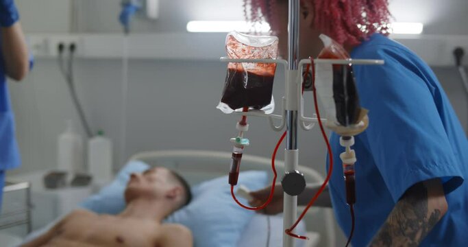 Blood transfusion to young male patient in hospital room